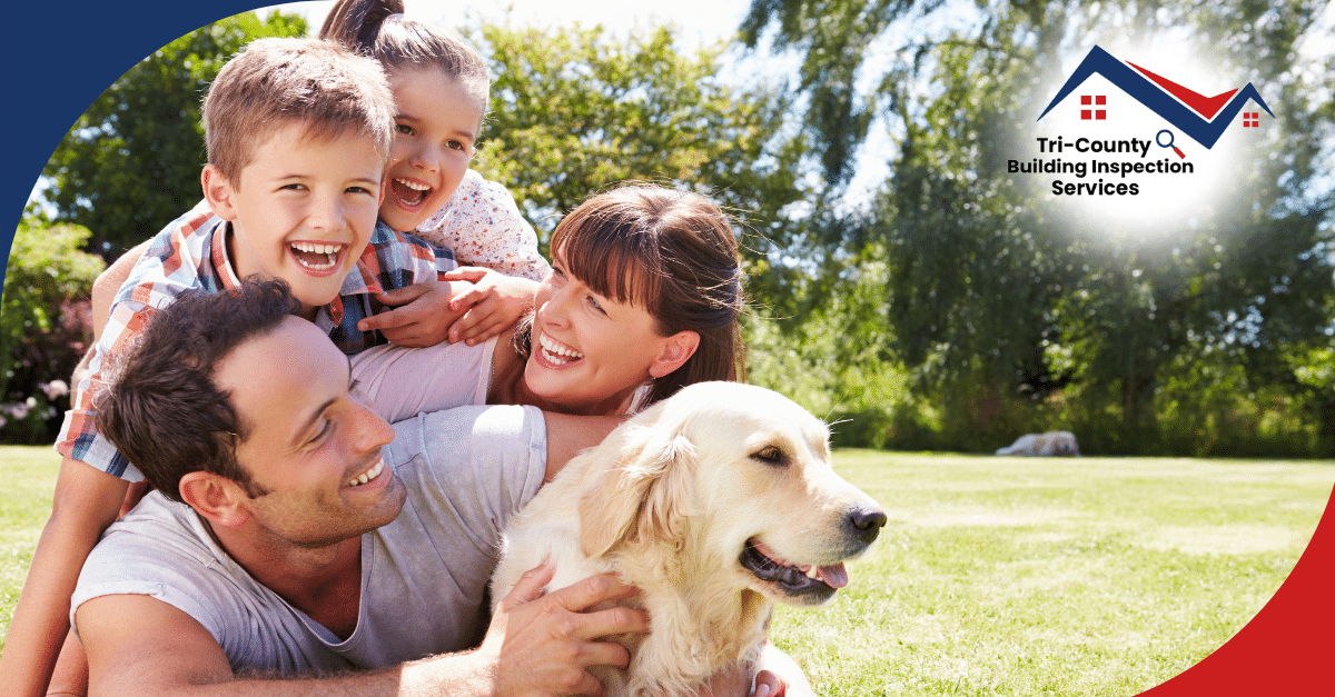 Happy family playing outside with their golden retriever.