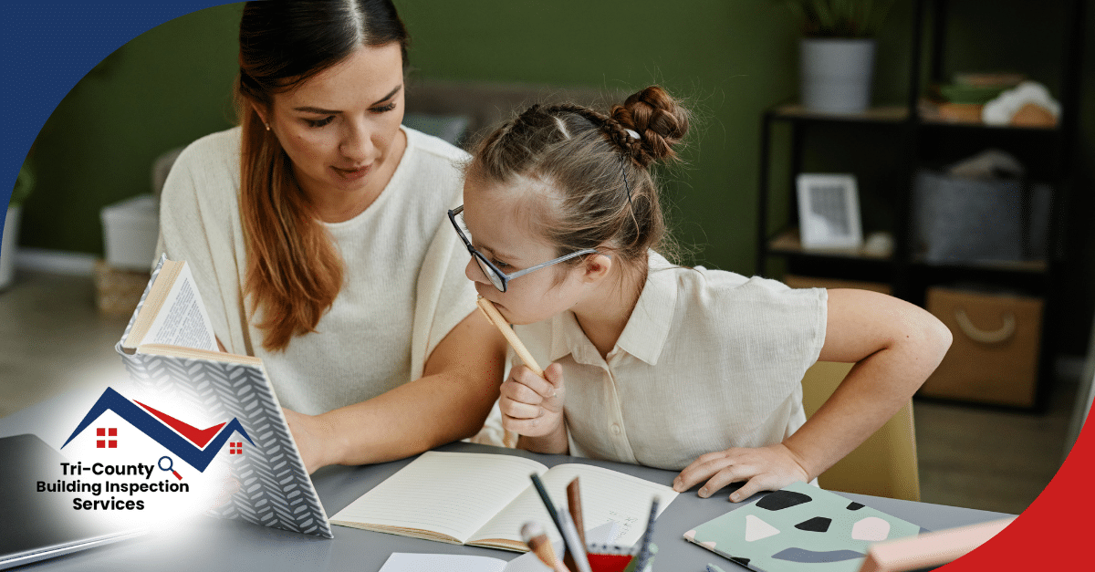 Woman helping a young girl with glasses study at a desk.